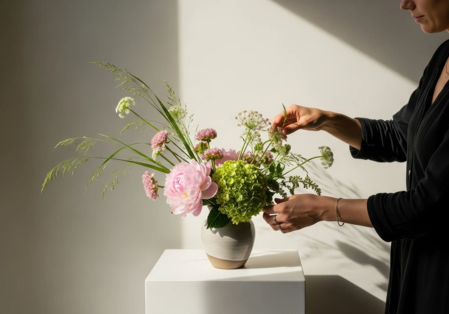 Arranging soft pink flowers for a memorial